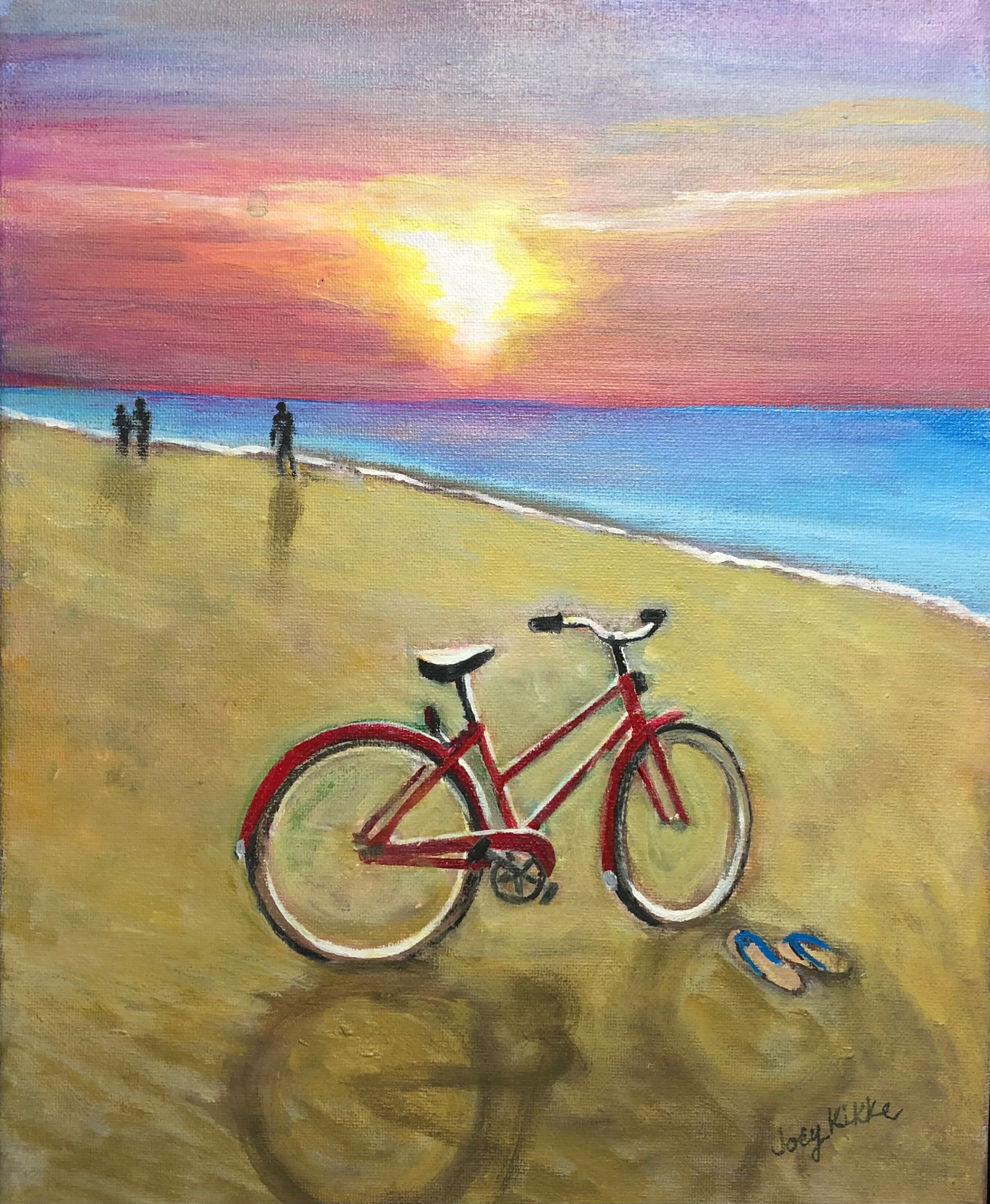 Red bike on the beach during sunset.